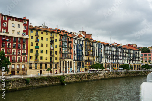 Obraz na płótnie Bilbao, Spain - 08.06.2022: Bright multi colored houses of the Nervion River. Colorful architecture, Bilbao, Spain. w salonie