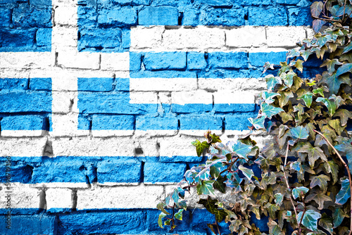 Greece grunge flag on brick wall with ivy plant