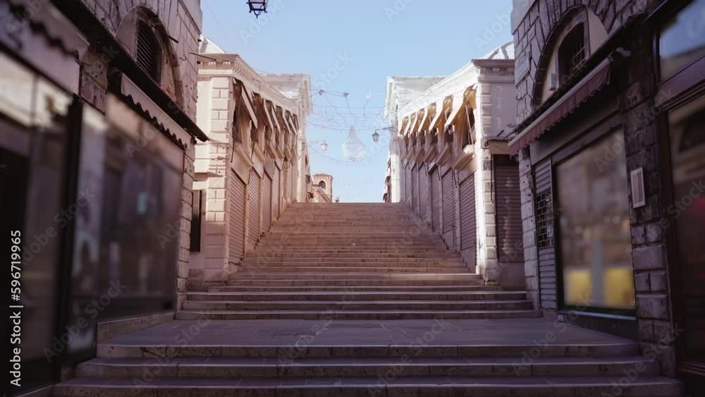 Motion between closed stores to steps of pedestrian Rialto Motion between closed stores to steps of pedestrian Rialto