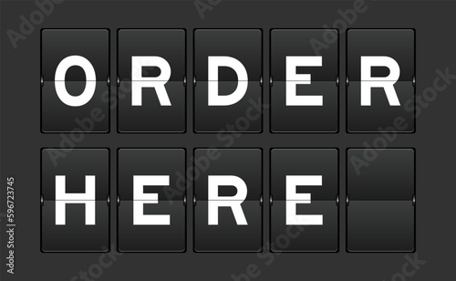 Black color analog flip board with word order here on gray background