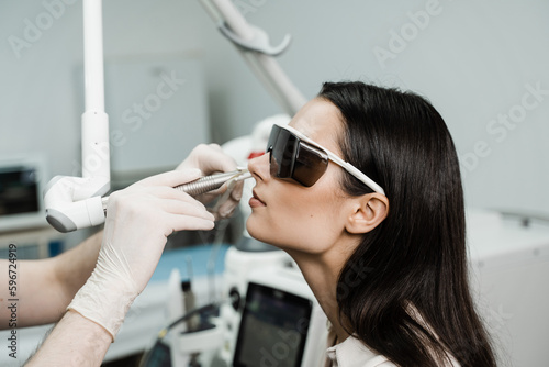 Tableau sur toile Laser treatment inflammation of the nasal lining, runny nose, sneezing symptoms