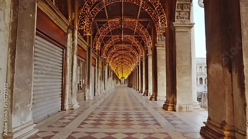 Motion past closed stores in arch passage with fairy lights photo