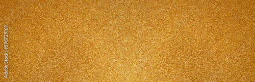 Gold glitter texture sparkling paper background. Abstract banner with twinkled golden glittering. Defocused lights for Christmas holiday. Flat lay mockup design.