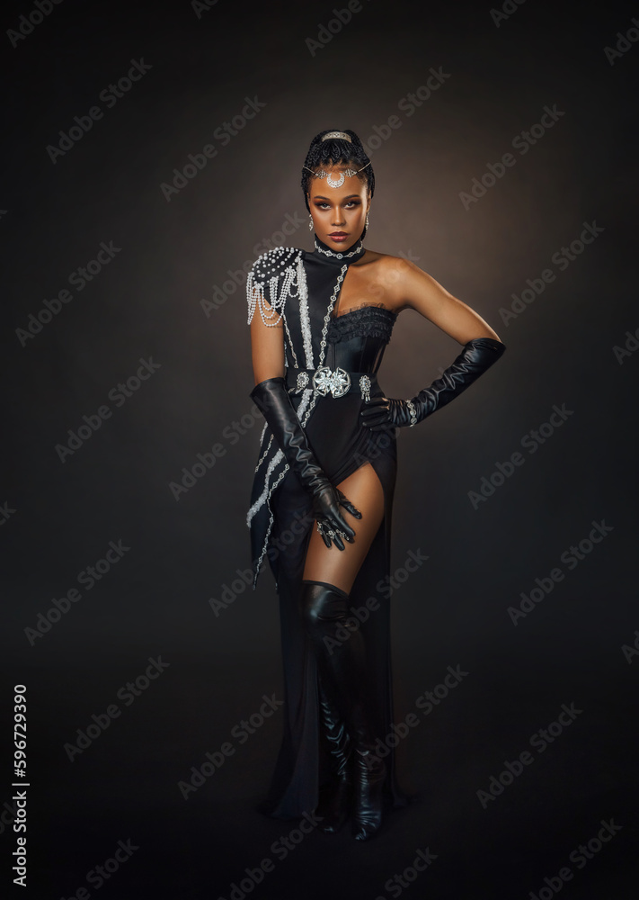 Naklejka premium Portrait fantasy african american woman dark queen in black military dress costume. Gothic lady fairy priestess of moon silver tiara. Sexy girl goddess beauty face fashion model posing. Studio photo