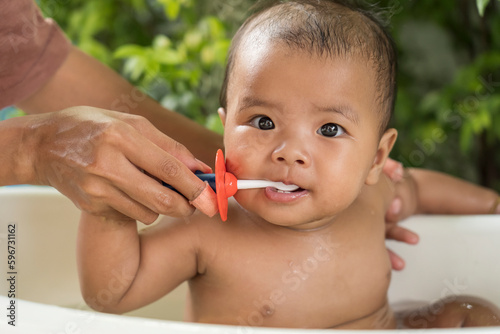 happy Asian Infant to brush teeth with mom. health care and cleaning teeth concept