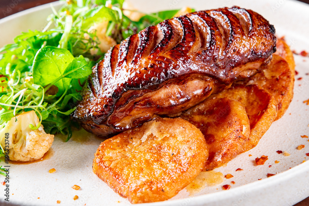 Roasted Duck breast fillets with vegetable salad and batat in plate
