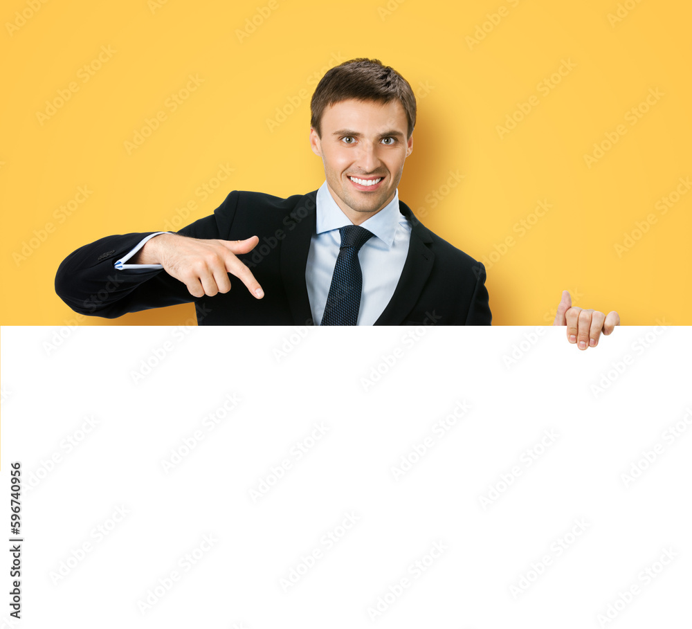 Image of business man professional bank manager in confident black suit. Businessman stand behind, hang over, show point finger empty white banner signboard. Isolated orange yellow background Image of business man professional bank manager in confident black suit. Businessman stand behind, hang over, show point finger empty white banner signboard. Isolated orange yellow background