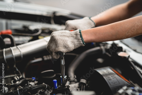 Concept of vehicle inspection and repair and maintenance services. Car maintenance, mechanic, mechanic, close-up, use wrench, repair, replace engine parts. Concepts of check and fix car and maintenanc