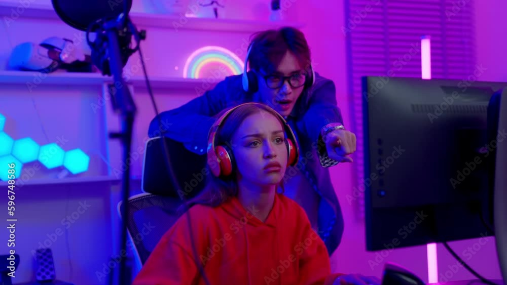 Portrait of young asian games women play computer pc. Teams lost, regretting the chance of win in tournament. Streaming game online at home. Lose and game over concept. Portrait of young asian games women play computer pc. Teams lost, regretting the chance of win in tournament. Streaming game online at home. Lose and game over concept.