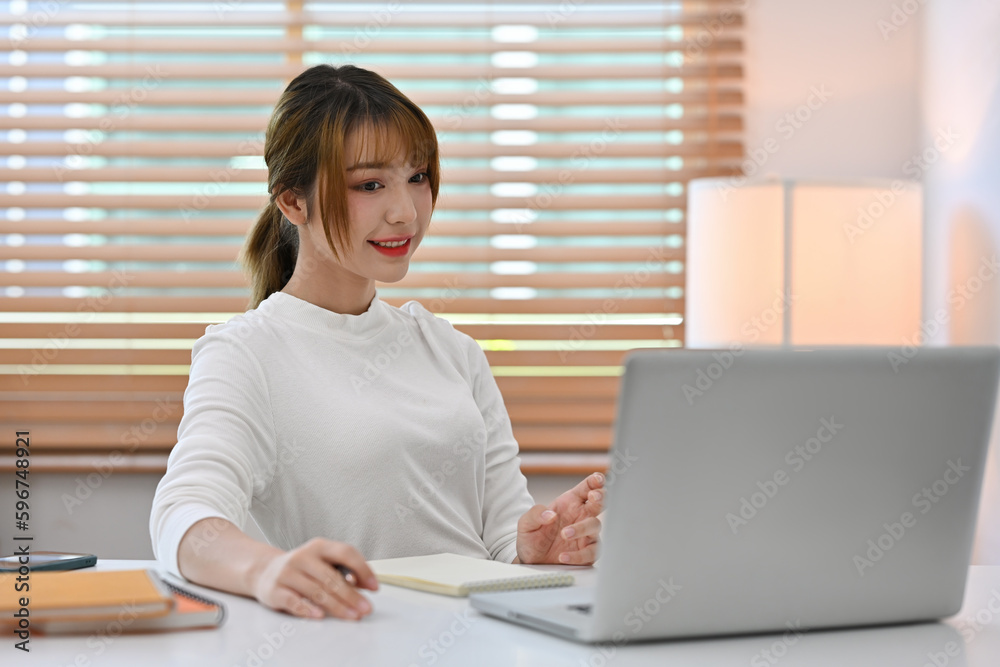 Young Millennial Business woman working at office desk with laptop computer. Young Millennial Business woman working at office desk with laptop computer.
