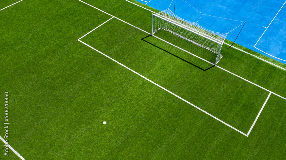 Fototapeta premium Aerial closeup of the penalty spot on an empty synthetic grass soccer field. Here a penalty is taken in a soccer game.