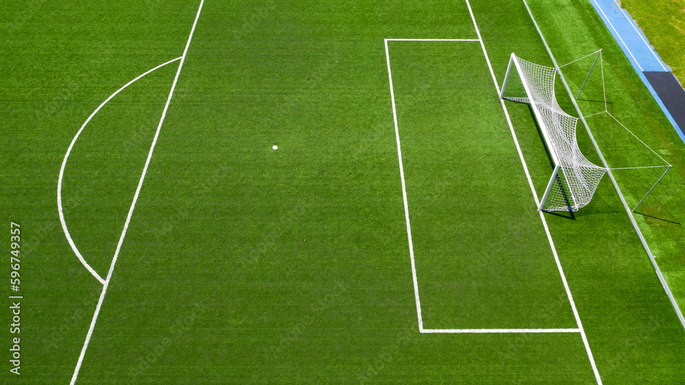 Aerial closeup of the penalty area on an empty synthetic grass soccer field. Here a penalty is taken in a soccer game. Aerial closeup of the penalty area on an empty synthetic grass soccer field. Here a penalty is taken in a soccer game.