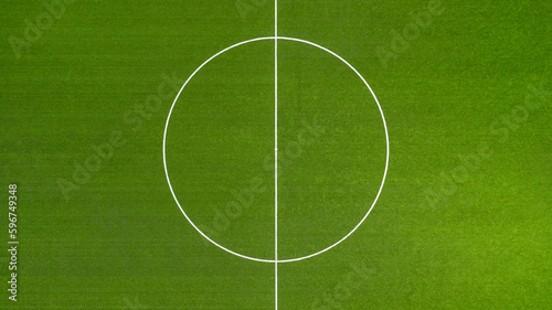 Aerial closeup of the midfield circle in an empty synthetic grass football field. Here the kick off is taken in a game of soccer. © Stefano Tammaro