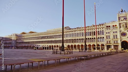 Doge palace with arches and columns on empty St Mark square photo