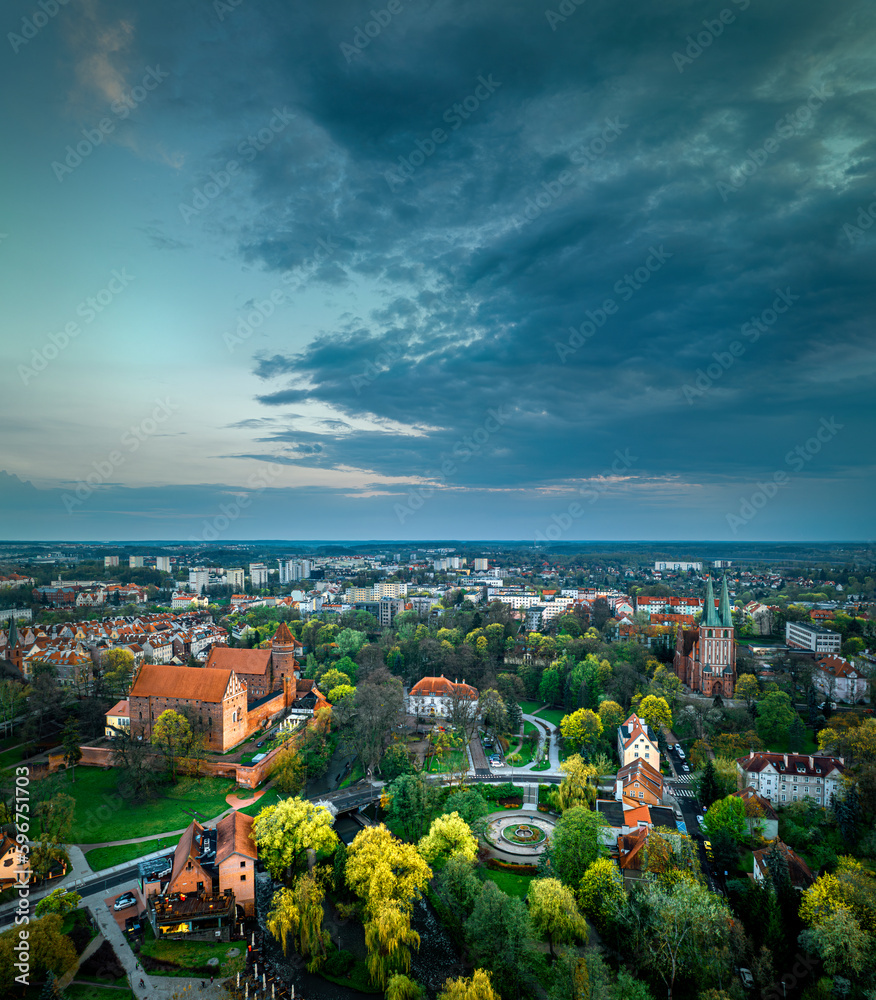 Olsztyn - park outside the castle, castle and garrison church from a bird's eye view. spring light after sunset.
