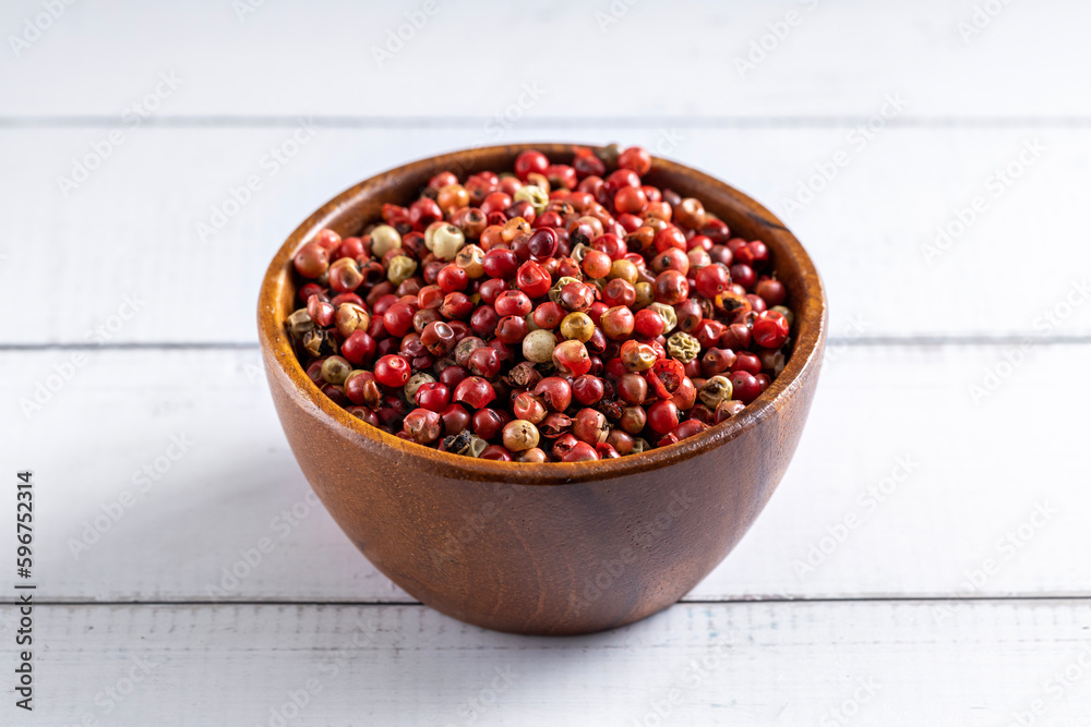 Red pepper seeds bowl. 45 degrees studio shoot on light wooden white background. Red pepper seeds bowl. 45 degrees studio shoot on light wooden white background.