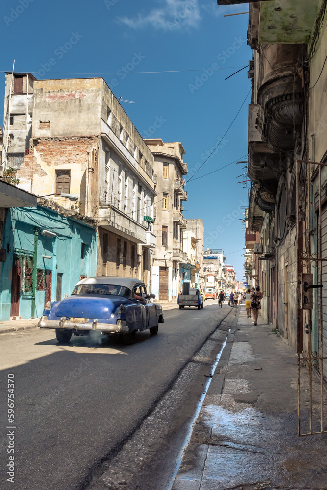 Old American car in Galiano street Havana Cuba with old buildings Old American car in Galiano street Havana Cuba with old buildings