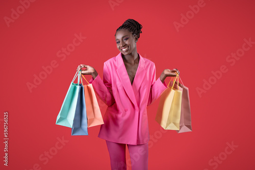 Beautiful Stylish Black Woman Posing With Shopping Bags In Hands