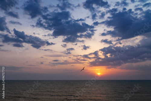 Fototapeta Naklejka Na Ścianę i Meble -  Sunset on the sea in the clouds with sun rays