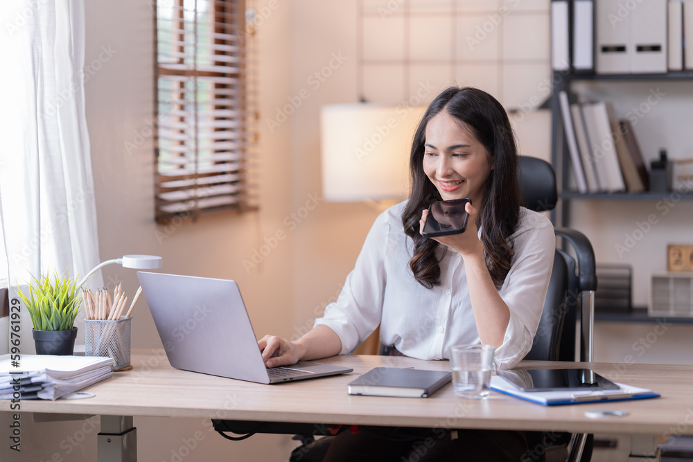Young happy businesswoman working with tablet and mobile phone in corporate office. Young happy businesswoman working with tablet and mobile phone in corporate office.