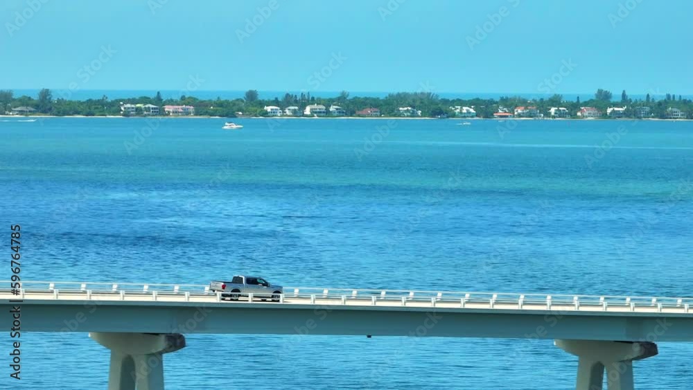 A truck crossing a bridge and going to an island