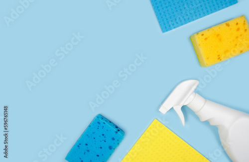Banner. Cleaning concept. Various cleaning products on a blue background. Top view. Copy space.
