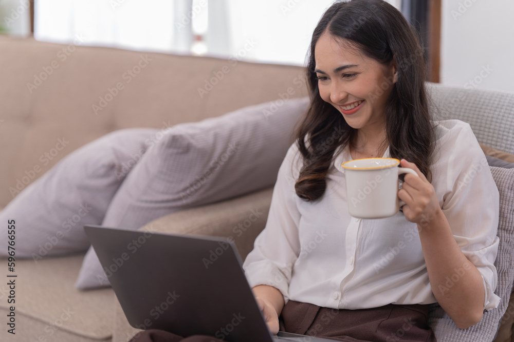 Full length photo of positive business girl sits floor legs crossed folded work remote laptop read document report hold mug beverage in house Full length photo of positive business girl sits floor legs crossed folded work remote laptop read document report hold mug beverage in house