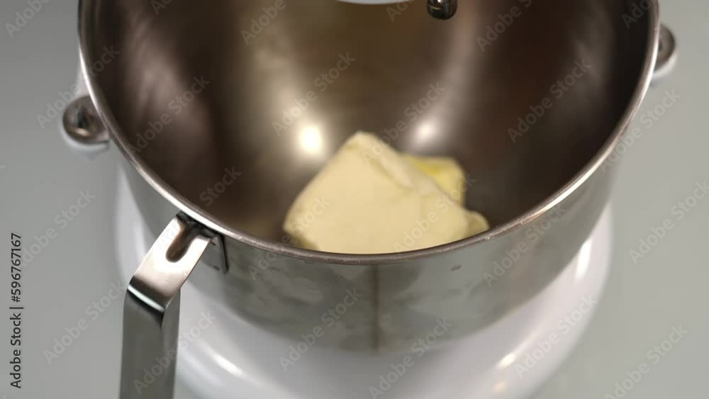Molt butter in metal container of modern dough maker Molt butter in metal container of modern dough maker