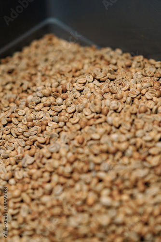 craft coffee production raw coffee beans lie in a box preparation for coffee roasting close-up