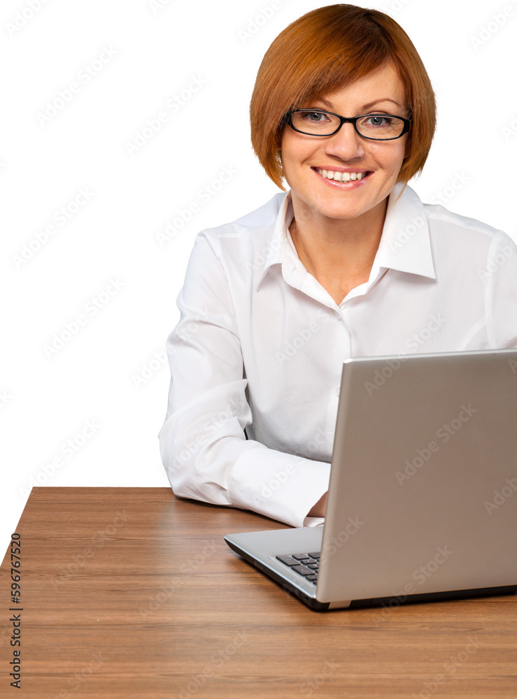 Businesswoman working on silver laptop Businesswoman working on silver laptop