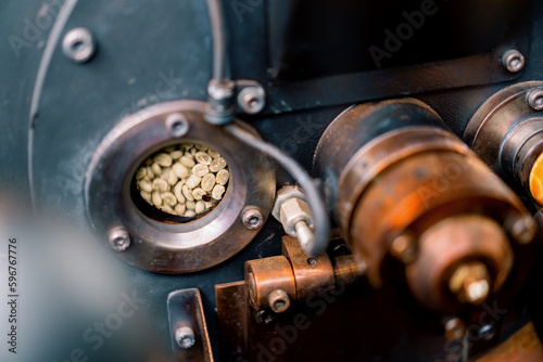 Coffee beans are rotated in a machine for roasting coffee beans close-up of craft coffee production