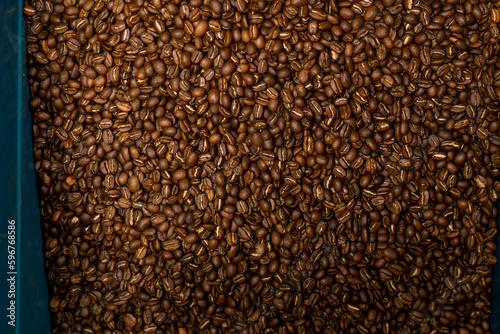 coffee production roasted and fragrant coffee beans lie in a box preparing for transportation close-up