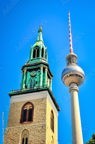 Berlin, Germany - May 03, 2014: TV Tower in Berlin, Germany. Old and new in Berlin: view towards the tower of St. Mary is Church (Marienkirche) and Berliner Fernsehturm in Alexanderplatz.