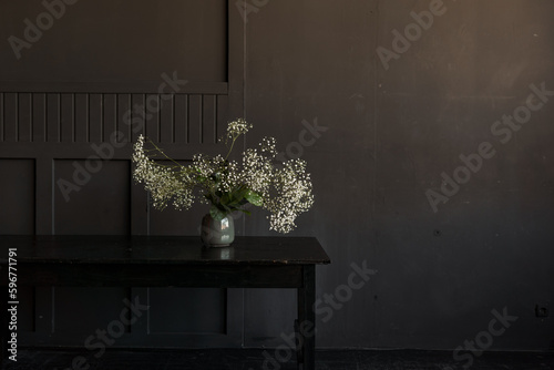 Modern vase in room with dark black textured wooden wall. modern style