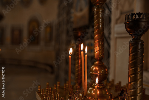 the atmosphere of the church, candles and yellow lights, bokeh background