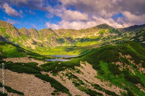 Lake in mountains in summer morning scenery. Picturesque view stretches over lakes in the Five Pond Valley and mountain ridge in Tatra Mountains, Poland.