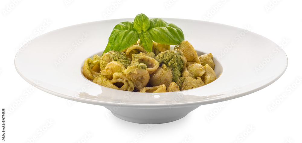 Macaroni pasta with pesto in a white dish with basil leaves, pesto is a typical Genoese sauce of basil, pine nuts, olive oil and parmesan cheese. 