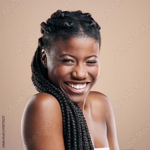 I wear my braids like a crown. Cropped portrait of an attractive young woman posing in studio against a brown background.