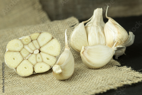 Fresh garlic close-up, cloves of garlic on a wooden background.