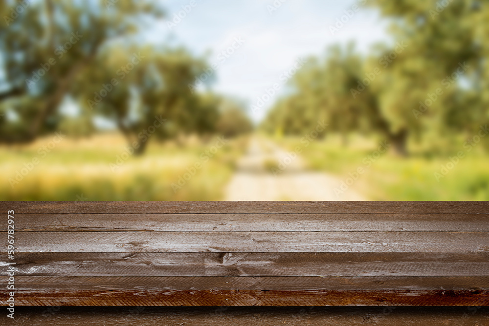 Empty wooden table with blur olives field, Mock up for display or montage of product,Banner or header for advertise on social media Empty wooden table with blur olives field, Mock up for display or montage of product,Banner or header for advertise on social media