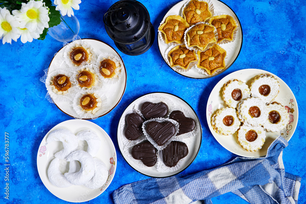 eid holiday table : Oriental Algerian sweet cookies named dziriettes and ( kaab el ghazal) translated in gazelle horns, heart shaped chocolate with jam apricot cookies eid holiday table : Oriental Algerian sweet cookies named dziriettes and ( kaab el ghazal) translated in gazelle horns, heart shaped chocolate with jam apricot cookies