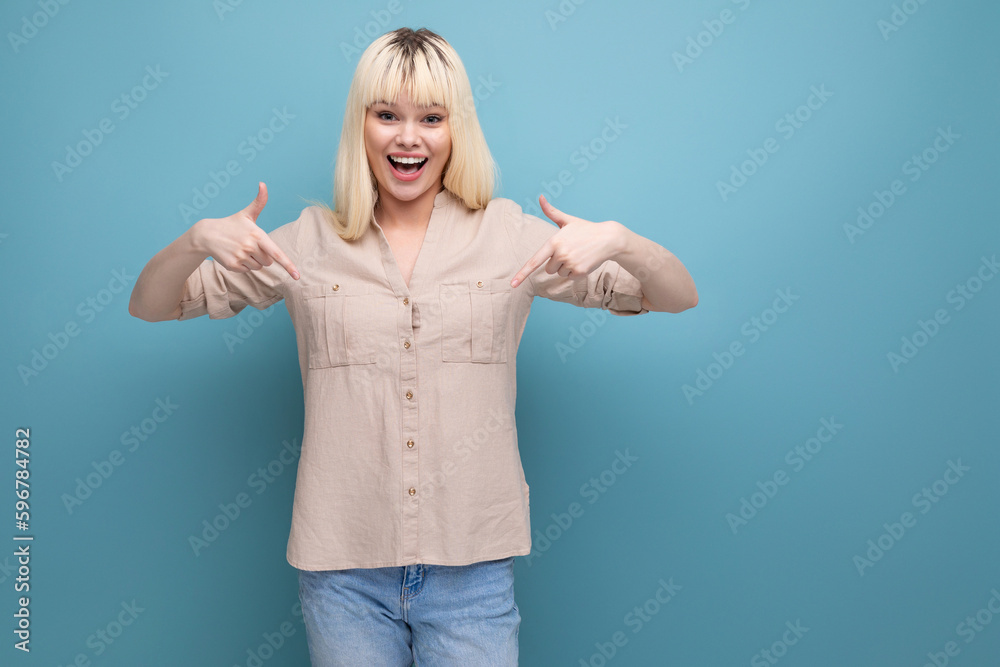 surprised young woman in casual shirt on studio background with copy space surprised young woman in casual shirt on studio background with copy space