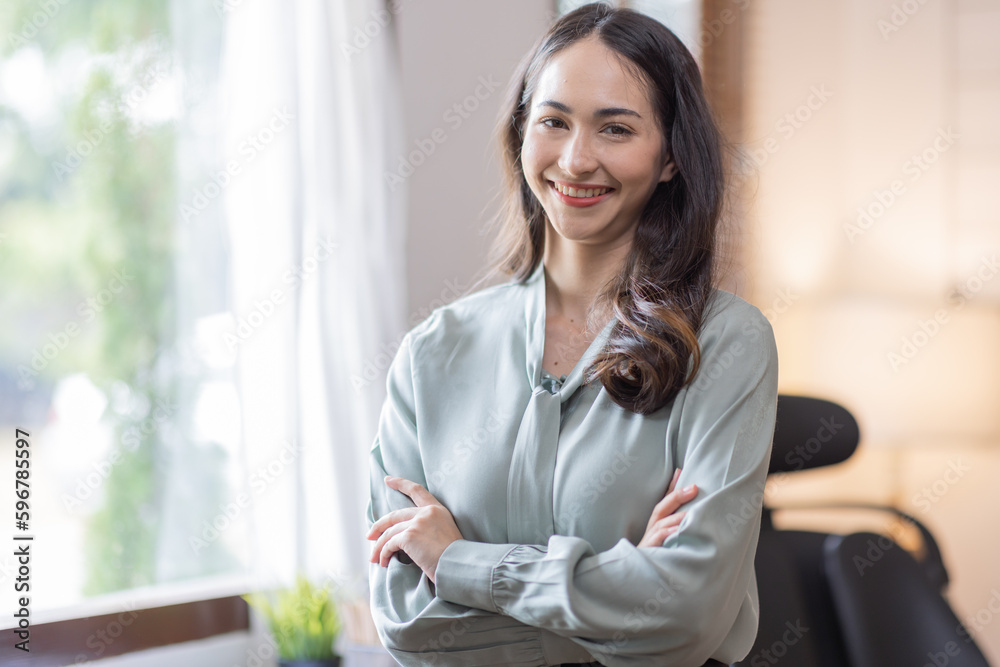Obraz premium Happy young business Asian woman posing isolated over grey office background.