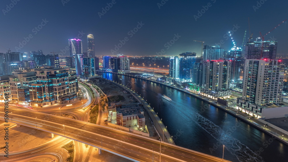 Skyscrapers at the Business Bay aerial day to night timelapse in Dubai, United Arab Emirates