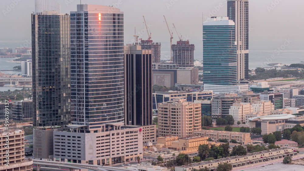Obraz premium Office buildings in Dubai Internet City and Media City district aerial night to day timelapse