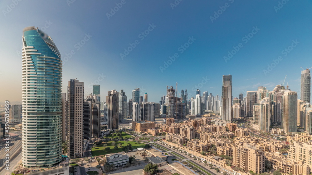 Obraz premium Panorama showing Dubai's business bay towers aerial morning timelapse. Rooftop view of some skyscrapers