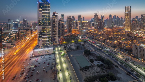 Dubai's business bay towers aerial day to night timelapse. Rooftop view of some skyscrapers