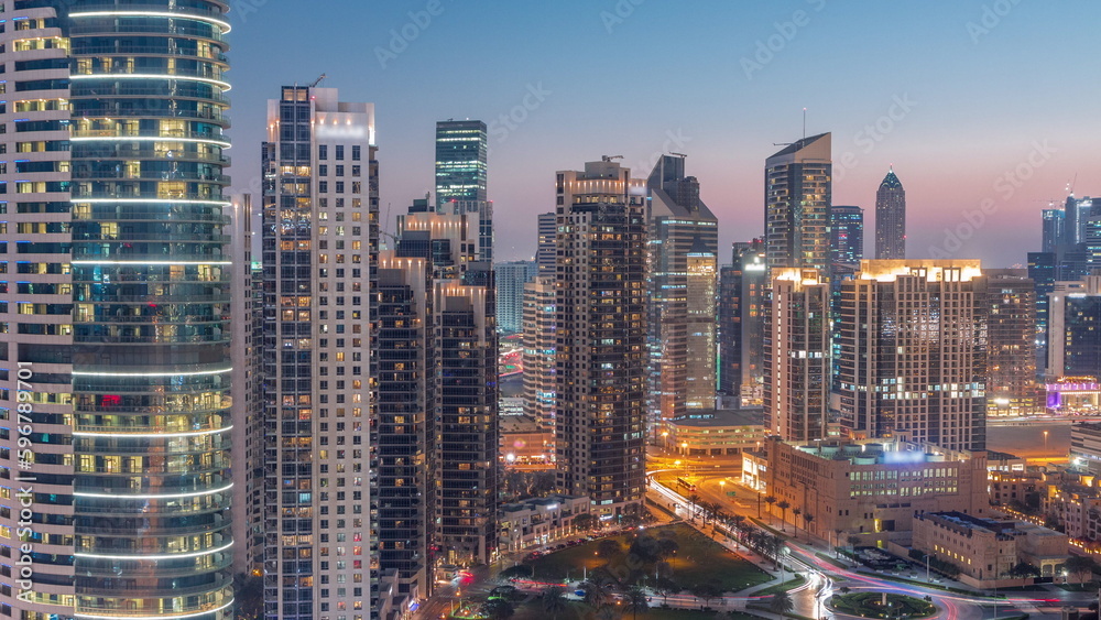 Dubai's business bay towers aerial day to night timelapse. Rooftop view of some skyscrapers