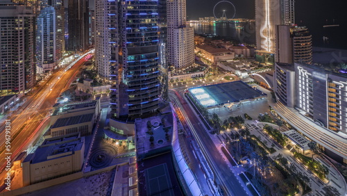 Panoramic view of the Dubai Marina and JBR area and the famous Ferris Wheel aerial night timelapse