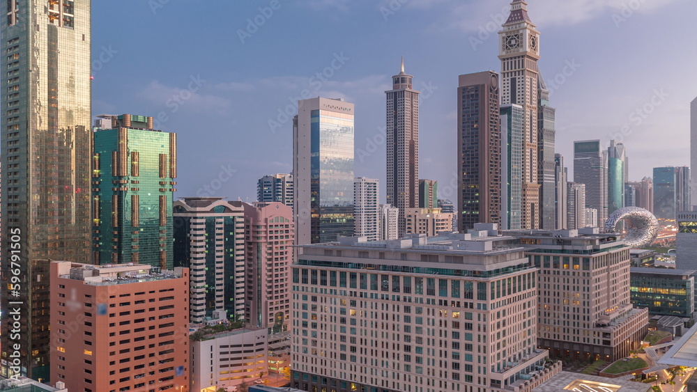 Fototapeta premium Dubai International Financial district aerial night to day timelapse. View of business office towers.